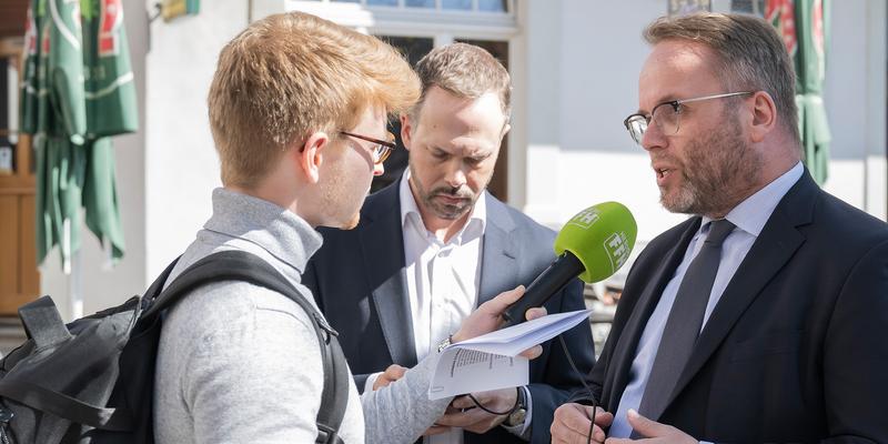 A journalist leads an interview with a politician.