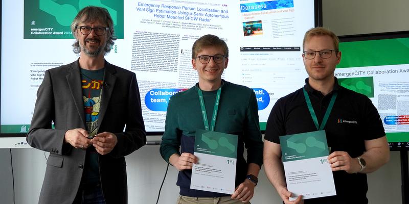 Three men are standing, two of them holding a certificate.