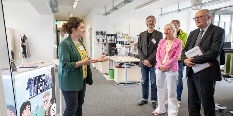 A Woman talking to three listeners