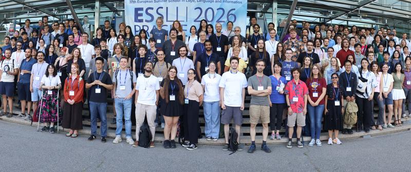 Round about 60 people in front of a banner with the ESSLLI logo