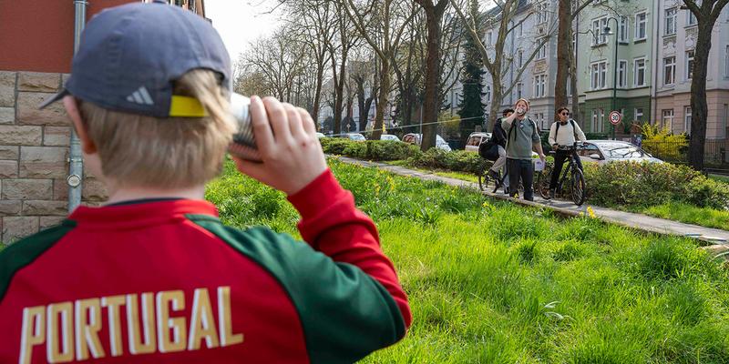 A family is experimenting with a cup phone.
