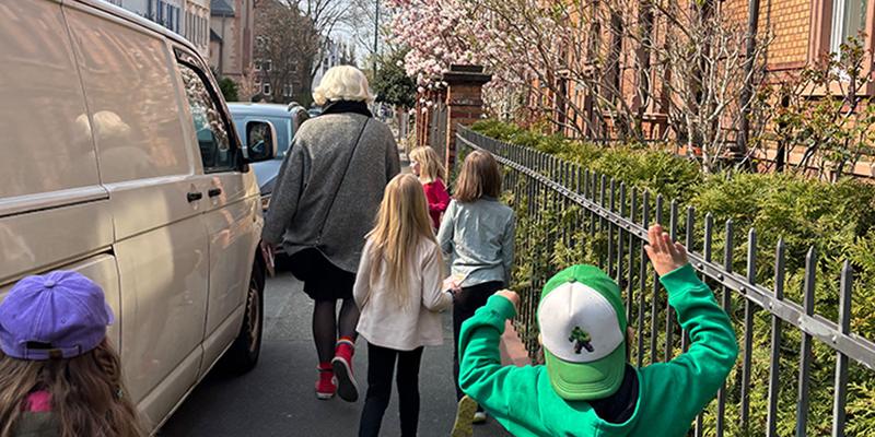From behind, you can see a few children following Aurora DeMeehl through the Lichtenberg block.